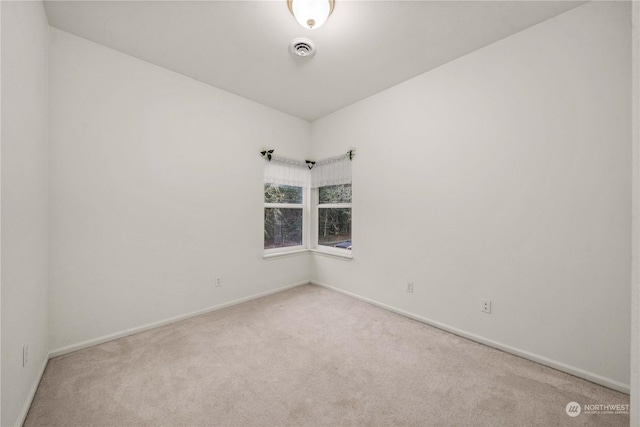 unfurnished room with light colored carpet