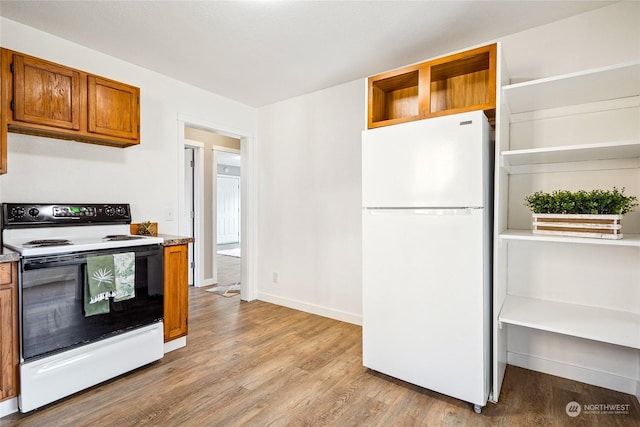 kitchen featuring light hardwood / wood-style flooring and white appliances