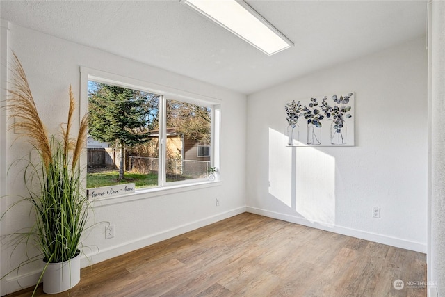 unfurnished room with wood-type flooring