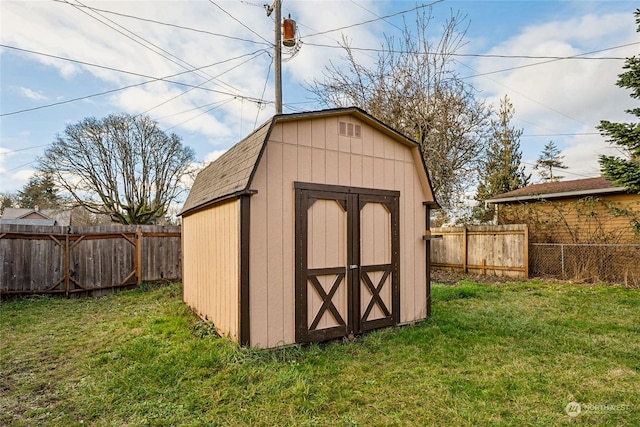 view of outbuilding featuring a lawn