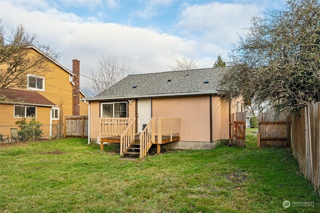 back of property featuring a yard and a wooden deck