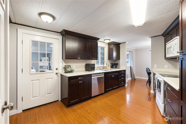 kitchen featuring dishwasher, light wood-type flooring, ornamental molding, dark brown cabinets, and electric range oven