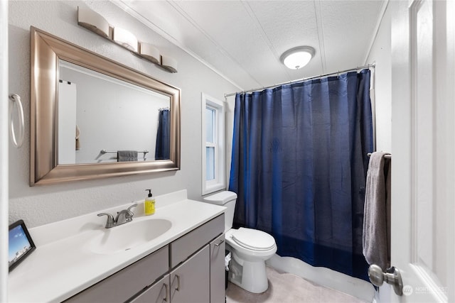 bathroom with vanity, a textured ceiling, and toilet