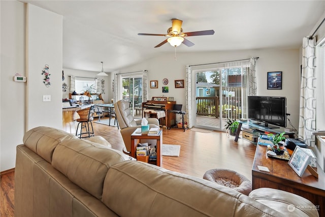 living room featuring hardwood / wood-style floors, ceiling fan, lofted ceiling, and a wealth of natural light