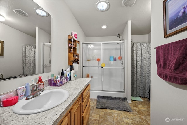 bathroom with a shower and vanity