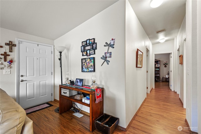 corridor with light hardwood / wood-style floors