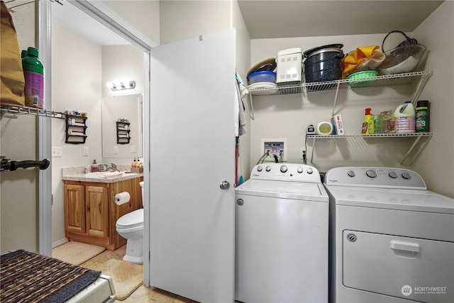 laundry area featuring sink, light tile patterned flooring, and independent washer and dryer