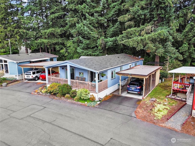 view of front of house with covered porch and a carport