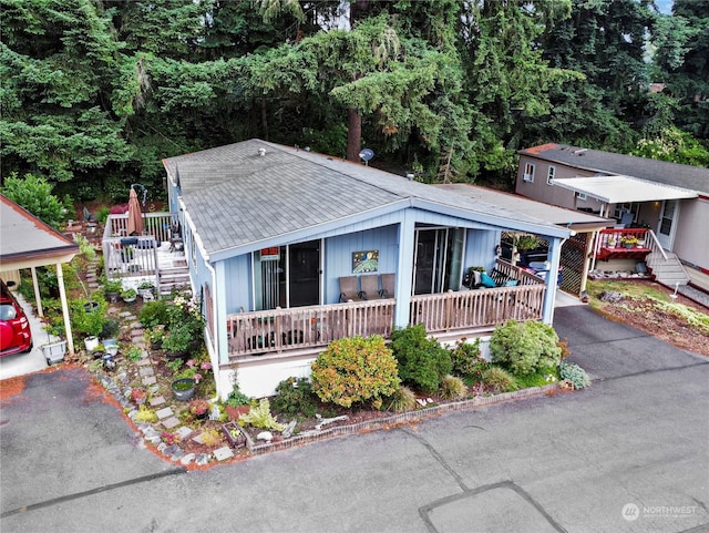 view of front of property featuring covered porch and a carport