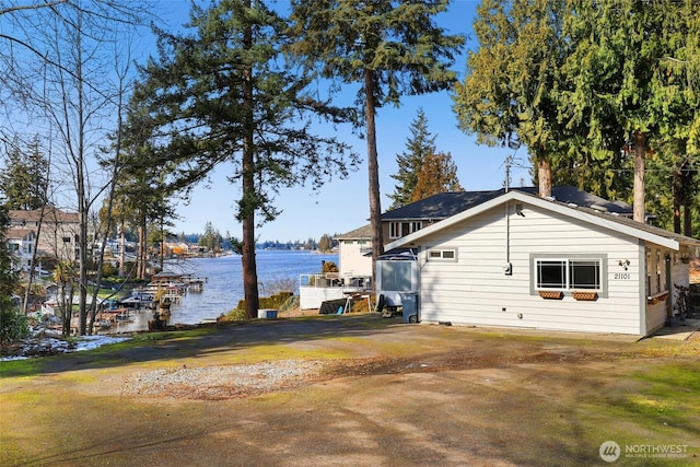 view of property exterior with a water view