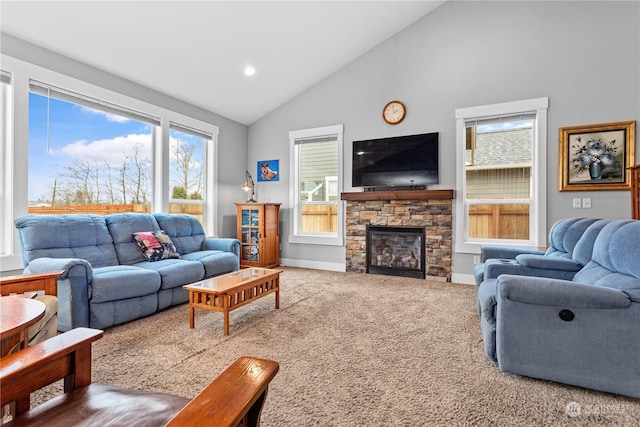 carpeted living room with high vaulted ceiling and a stone fireplace