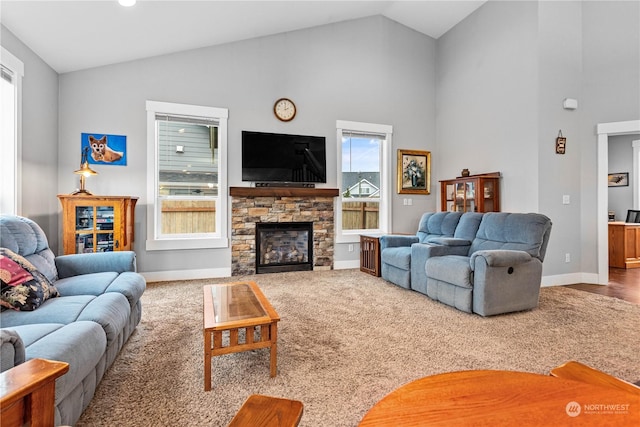 living room with a fireplace, carpet, a healthy amount of sunlight, and high vaulted ceiling