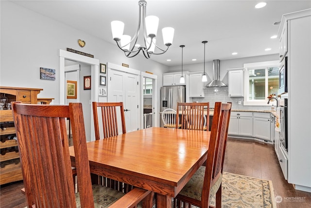 dining area with a chandelier and dark hardwood / wood-style floors