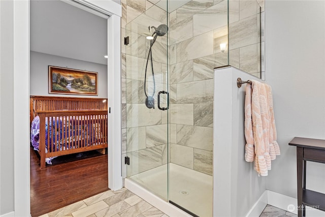 bathroom featuring a shower with door