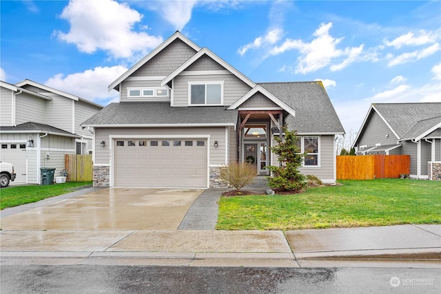 view of front of house featuring a garage and a front lawn