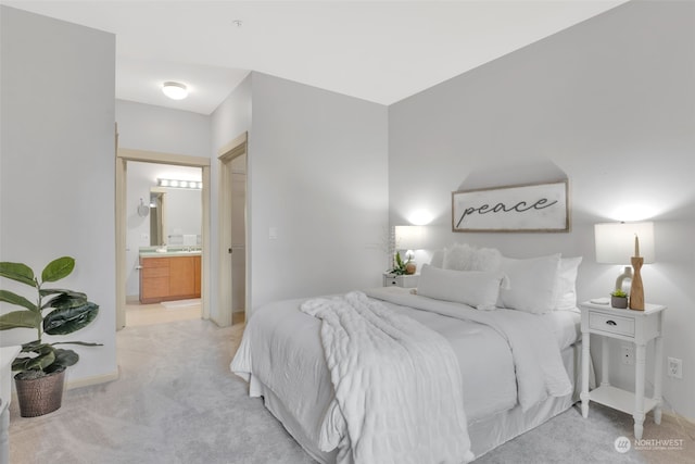 bedroom with light carpet and ensuite bath