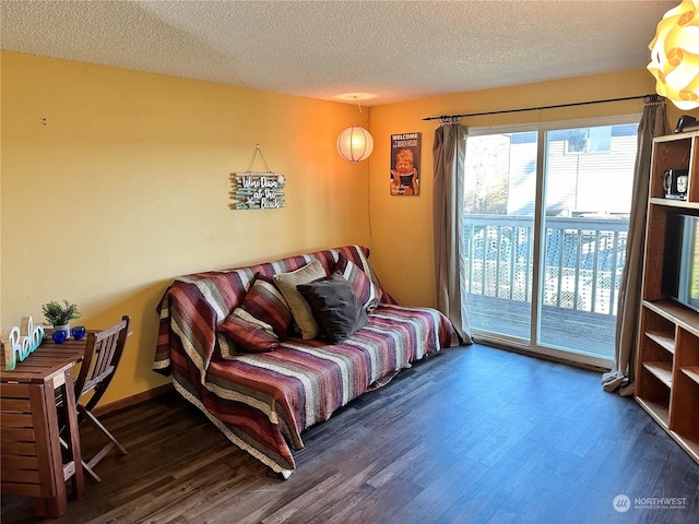 living room with dark hardwood / wood-style floors and a textured ceiling