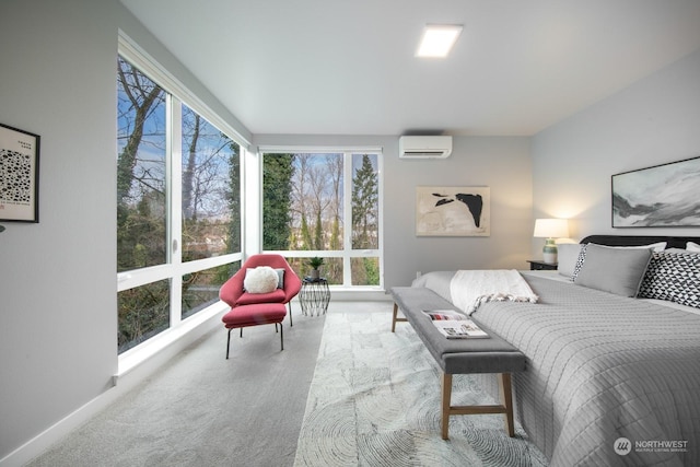 bedroom featuring an AC wall unit and light carpet