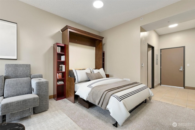 bedroom featuring light tile patterned floors and a textured ceiling