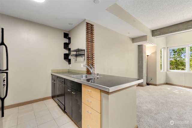 kitchen featuring kitchen peninsula, light carpet, light brown cabinetry, and sink