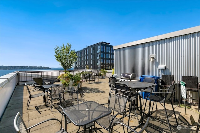 view of patio featuring a grill and a water view