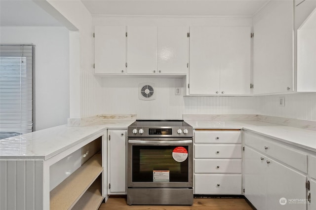 kitchen featuring wood-type flooring, white cabinetry, and stainless steel electric range