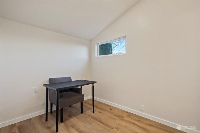 home office featuring light wood-type flooring and lofted ceiling