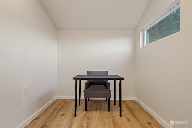 home office with light hardwood / wood-style flooring