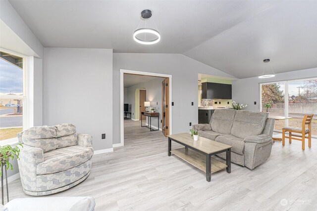 living room with light hardwood / wood-style flooring and lofted ceiling