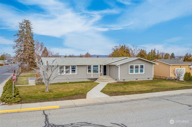 ranch-style home with a front lawn