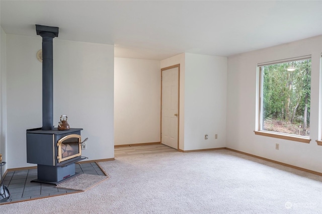 living room with a wood stove and carpet floors