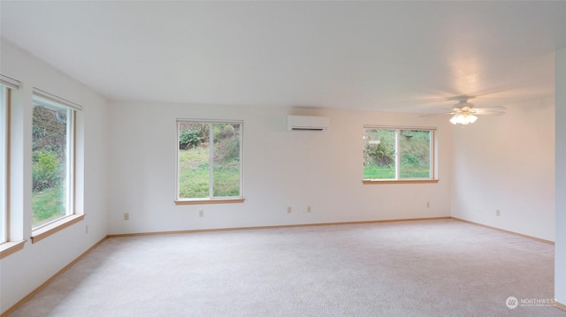 empty room featuring ceiling fan, light colored carpet, and an AC wall unit