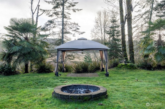 view of yard featuring a gazebo and an outdoor fire pit