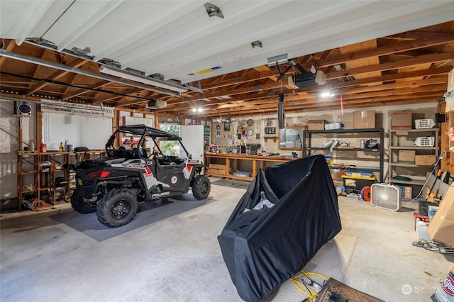 garage with a workshop area and a garage door opener