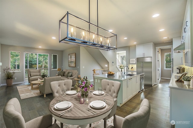 dining room with dark wood-type flooring, recessed lighting, and a wealth of natural light