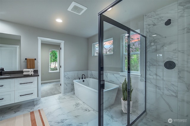 full bathroom with visible vents, plenty of natural light, marble finish floor, and vanity