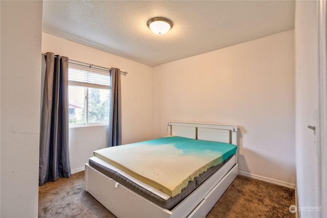 carpeted bedroom with a textured ceiling