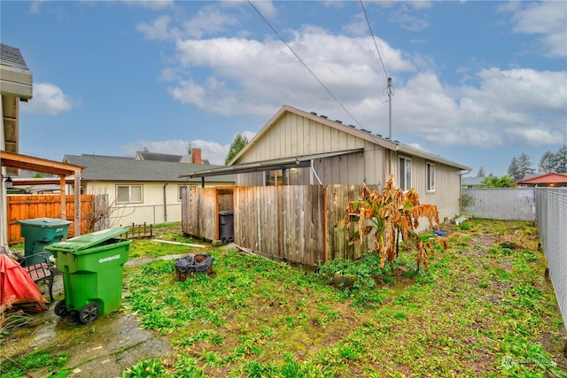 back of property with an outdoor fire pit