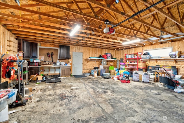 garage with a workshop area and a garage door opener