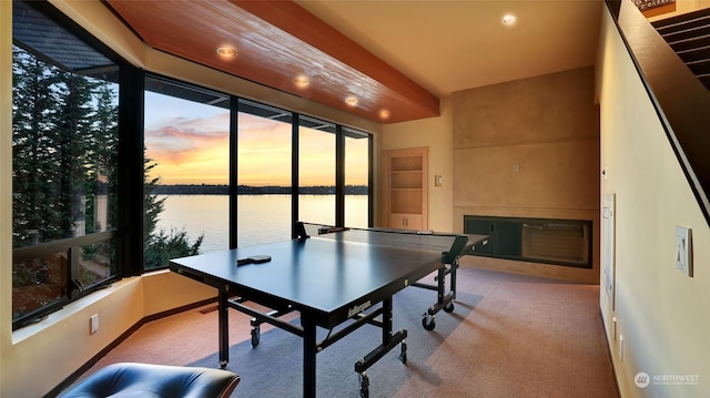 playroom with light carpet and a water view