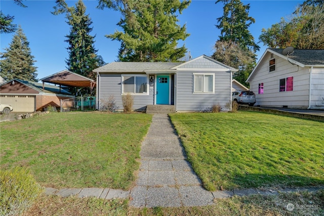 view of front facade with a garage, a front yard, an outdoor structure, and a carport