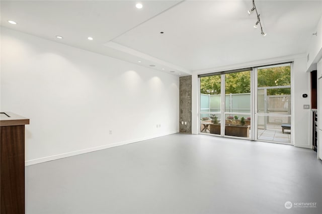 spare room featuring concrete floors and track lighting