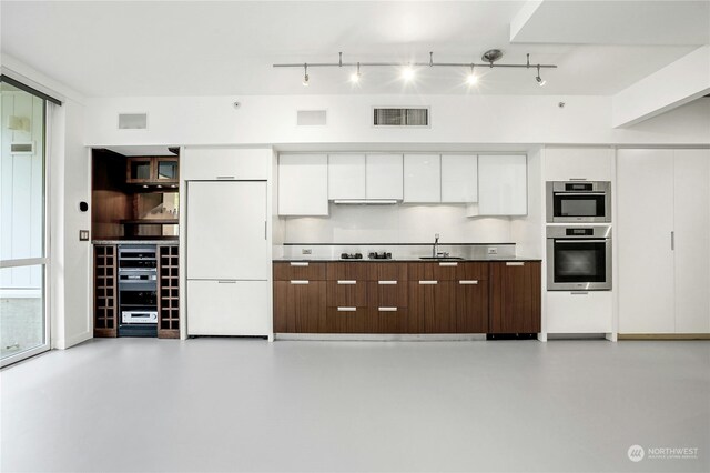 kitchen featuring sink, dark brown cabinets, white fridge, white cabinetry, and gas cooktop