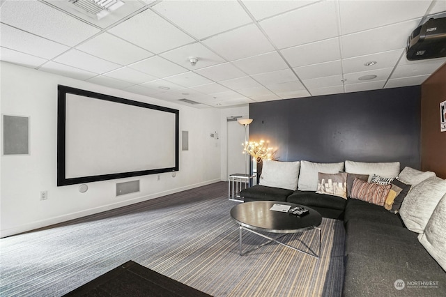 cinema with a drop ceiling and dark colored carpet