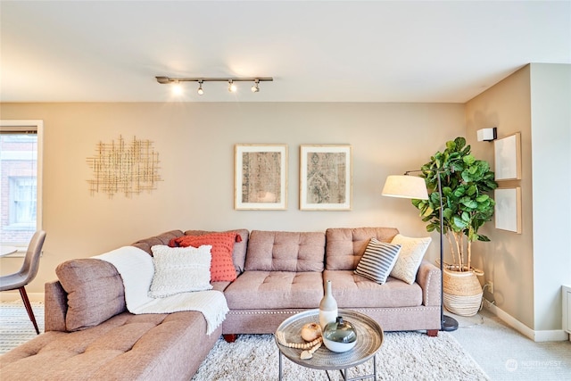 living room with carpet flooring and rail lighting