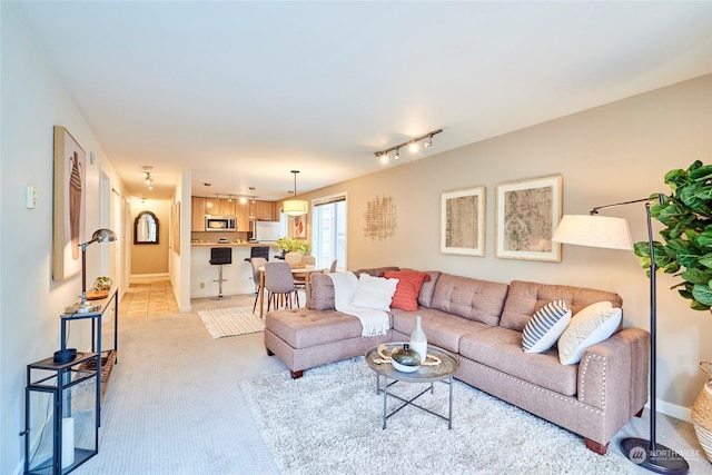 carpeted living room featuring track lighting