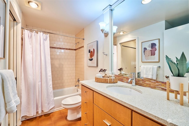 full bathroom with tile patterned flooring, shower / tub combo with curtain, vanity, and toilet