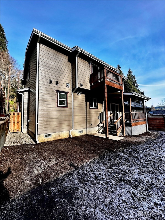 rear view of property featuring a balcony