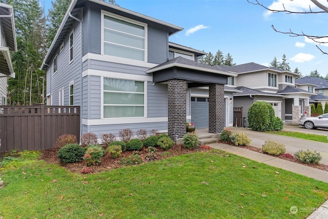 view of front of home with a garage and a front yard