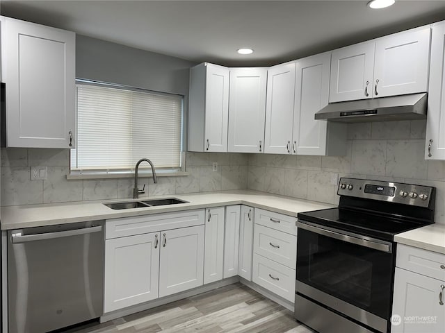 kitchen featuring white cabinets, stainless steel appliances, and sink